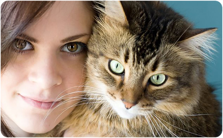 Close-up image of a woman and cat
